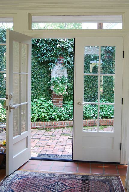 French doors opening onto a courtyard Garden style bringing the outdoors in