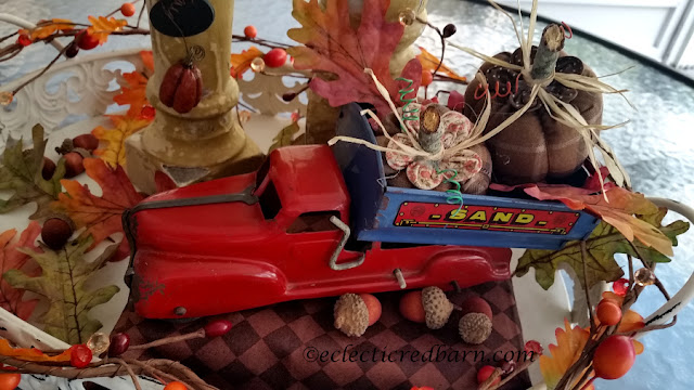 Pumpkins, Spindles, and Vintage Truck Share NOW. #falldecor. #fallvignette #pumpkins #vinatge #eclecticredbarn