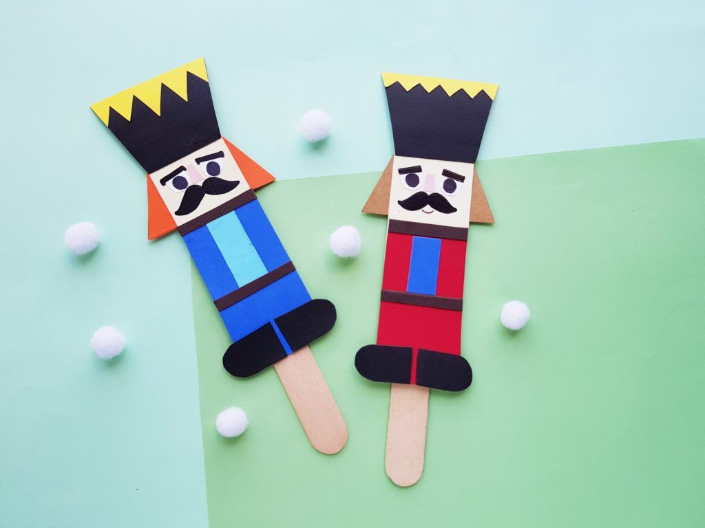 two nutcracker craft puppets on green and blue background